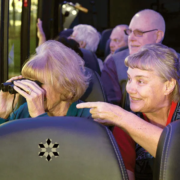 Retired individuals on a bus looking through binoculars!, Kavod Senior Life, Assisted Living in Denver, CO