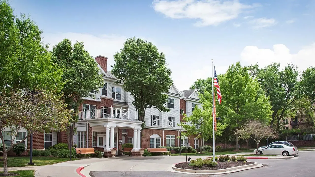 Stately three-story red brick assisted living and memory care building at The Village at Mission in Prairie Village, KS, Johnson County.
