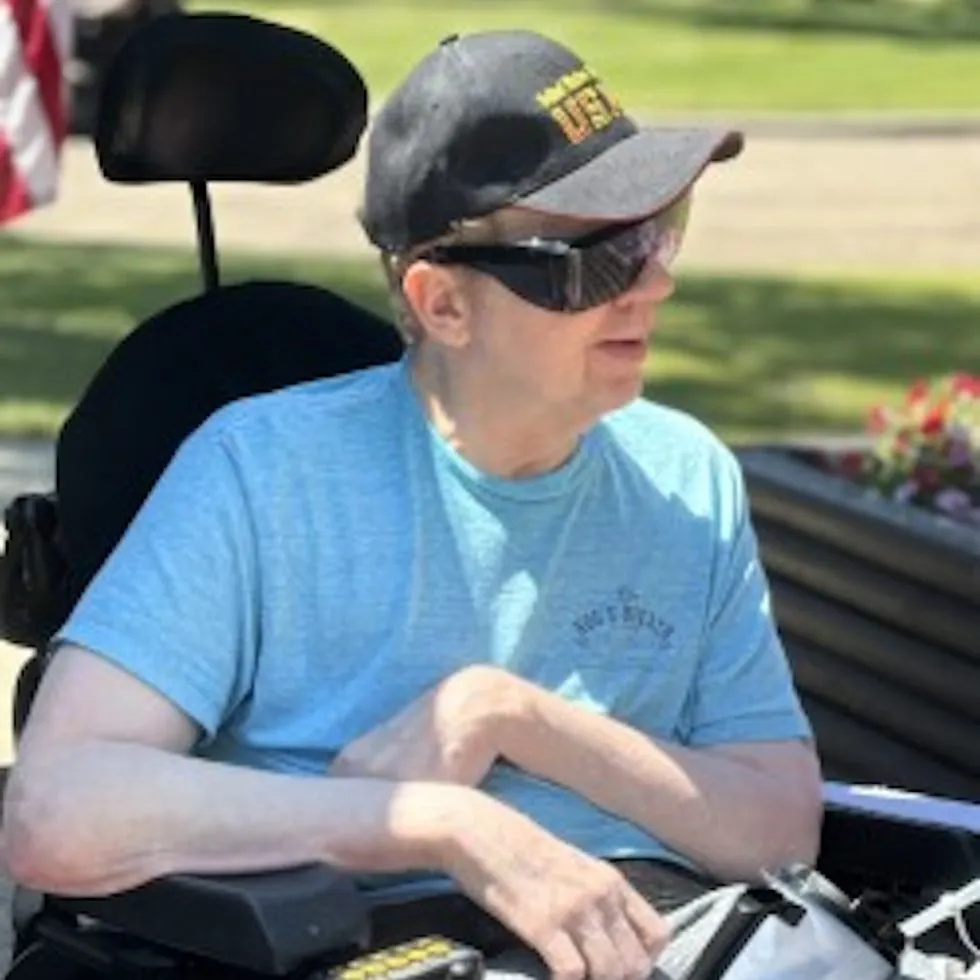 Resident enjoying a sunny day outdoors, embracing community and independence at the retirement home.